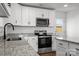 This kitchen features stainless steel appliances, granite countertops and a white door to the exterior at 3000 Celia Ave, Charlotte, NC 28216