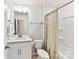 Bright bathroom featuring a single sink vanity with brushed-nickel fixtures, and a tub/shower combo at 9126 Vecchio Dr, Indian Land, SC 29707