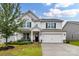 Charming two-story home with a manicured front yard, a welcoming porch, and a two-car garage at 9126 Vecchio Dr, Indian Land, SC 29707