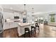 Bright, open kitchen with a center island, pendant lighting, and a seamless transition to the dining area at 9126 Vecchio Dr, Indian Land, SC 29707