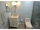 Updated bathroom with vanity sink, a modern toilet, and tiled shower with a glass door at 18867 Vineyard Point Ln, Cornelius, NC 28031