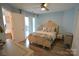 A comfortable bedroom with a private balcony, wood-look flooring, and light blue walls at 18867 Vineyard Point Ln, Cornelius, NC 28031