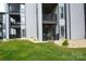 Condo's exterior featuring a lawn, gray siding, balconies with dark railings, windows and sliding glass doors at 18867 Vineyard Point Ln, Cornelius, NC 28031