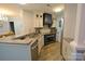 An open kitchen featuring stainless steel appliances, granite countertops, and tile backsplash at 18867 Vineyard Point Ln, Cornelius, NC 28031