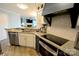 This kitchen features granite countertops, stainless steel appliances, and modern white cabinets at 18867 Vineyard Point Ln, Cornelius, NC 28031
