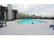 Enjoy the community pool surrounded by lounge chairs and views of the complex and nearby lake at 18867 Vineyard Point Ln, Cornelius, NC 28031