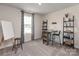 Bright bedroom with a work space, a large window with blue curtains, a stool, and storage shelves at 153 Shepherds Landing Dr, Mooresville, NC 28115