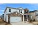 Two-story home with brick and vinyl siding, showing a concrete driveway and a two-car garage on a sunny day at 153 Shepherds Landing Dr, Mooresville, NC 28115