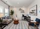 Inviting living room with a modern sofa, a patterned rug, a large window, and a home office setup at 153 Shepherds Landing Dr, Mooresville, NC 28115