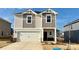 Beautiful home showcasing a two-car garage, neutral siding, and attractive architectural details on a sunny day at 157 Shepherds Landing Dr, Mooresville, NC 28115