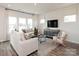 Cozy living room featuring neutral decor, plush seating, and ample natural light through large windows at 157 Shepherds Landing Dr, Mooresville, NC 28115