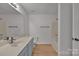 Main bathroom with tub, double vanity, and light wood floors at 5346 Johnston Mill Ct, Charlotte, NC 28269