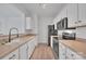 Modern kitchen featuring stainless steel appliances and light wood cabinets at 5346 Johnston Mill Ct, Charlotte, NC 28269