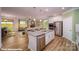 Modern, open-concept kitchen featuring stainless steel appliances, a large island, and a view into the living room at 121 Sari St, Troutman, NC 28166