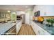 Modern kitchen features an island with a stainless steel sink and faucet, granite countertops, and stainless appliances at 121 Sari St, Troutman, NC 28166