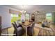 Open concept living area featuring a dining table and chairs, a fireplace, and lots of natural light at 121 Sari St, Troutman, NC 28166