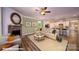 Open-concept living room with a fireplace, couch, and view of modern kitchen at 121 Sari St, Troutman, NC 28166
