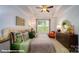 Well-lit bedroom boasts a cozy reading nook and stylish decor at 121 Sari St, Troutman, NC 28166