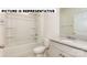 Bathroom with granite vanity, tub, and shelving at 131 Sari St, Troutman, NC 28166