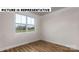 Bright bedroom featuring a large window and wood-look floors at 131 Sari St, Troutman, NC 28166