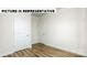 Spacious bedroom with wood-look floors and two closets at 131 Sari St, Troutman, NC 28166