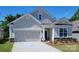 Two-story Craftsman home with neutral siding and a two-car garage at 131 Sari St, Troutman, NC 28166