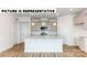 Modern kitchen with granite countertops, an island, and stainless steel appliances at 131 Sari St, Troutman, NC 28166
