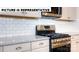 Close-up of kitchen range and white subway tile backsplash at 131 Sari St, Troutman, NC 28166