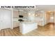 Modern kitchen with an island, white cabinets, and granite countertops at 131 Sari St, Troutman, NC 28166
