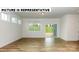 Living area with hardwood floors, sliding glass doors, and large windows at 131 Sari St, Troutman, NC 28166