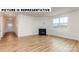 Spacious living room with a corner fireplace and hardwood floors at 131 Sari St, Troutman, NC 28166
