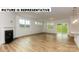 Open living space with fireplace, hardwood floors, and sliding glass doors at 131 Sari St, Troutman, NC 28166