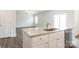 Kitchen island with granite countertop and sink at 179 Wembury Ln, Troutman, NC 28166