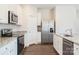 Modern kitchen with stainless steel appliances and granite countertops at 179 Wembury Ln, Troutman, NC 28166