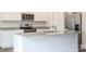 Modern kitchen with white cabinets, granite countertops, and stainless steel appliances at 179 Wembury Ln, Troutman, NC 28166