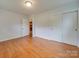 Bedroom with hardwood floors and access to the hallway at 2626 S Main St, Concord, NC 28027