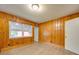 Bedroom with wood paneling, a window for natural light, and wood laminate flooring at 2626 S Main St, Concord, NC 28027