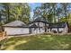 Backyard of home featuring a well-manicured lawn, deck, and a two-car garage at 2733 Wellington St, Rock Hill, SC 29732