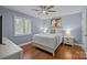 Comfortable bedroom with hardwood floors, neutral paint, a ceiling fan, and plantation shutters at 2733 Wellington St, Rock Hill, SC 29732