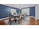 Formal dining room with blue accent wall, chandelier, and large window with shutters at 2733 Wellington St, Rock Hill, SC 29732