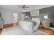 Comfortable bedroom featuring hardwood floors, a ceiling fan, and an ensuite bathroom at 2733 Wellington St, Rock Hill, SC 29732