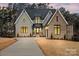 Beautiful new construction home with a large driveway, brick and siding exterior, and manicured landscaping at 4069 Rivendell Rd # 5, Denver, NC 28037