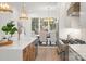 Modern kitchen island featuring a sink and faucet, stainless steel appliances, and view into the dining area at 4069 Rivendell Rd # 5, Denver, NC 28037