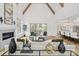 Bright living room featuring vaulted ceilings, exposed wood beams, fireplace, and an open-concept design at 4069 Rivendell Rd # 5, Denver, NC 28037