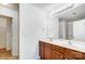 Bathroom with double sinks, wood vanity, and large mirror with decorative vanity lighting at 9345 Hamel St, Charlotte, NC 28215