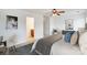 Spacious bedroom with neutral paint, ceiling fan, and hardwood floors leads to a view of an attached bathroom at 9345 Hamel St, Charlotte, NC 28215