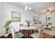 Dining room featuring hardwood floors, modern chandelier, and a round marble table that seats four at 9345 Hamel St, Charlotte, NC 28215