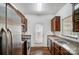 Kitchen with stainless steel appliances, granite countertops, ample cabinet space, and access to the back patio at 9345 Hamel St, Charlotte, NC 28215