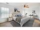 Bright main bedroom with ceiling fan, large windows, and a dedicated workspace with a desk and chair at 9345 Hamel St, Charlotte, NC 28215