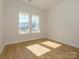 Spacious bedroom with two windows and hardwood floors at 1118 Lowland Way, Waxhaw, NC 28173